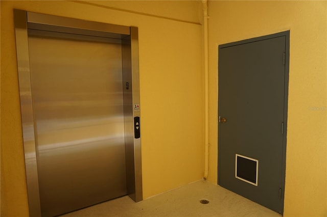 interior space featuring light carpet and elevator