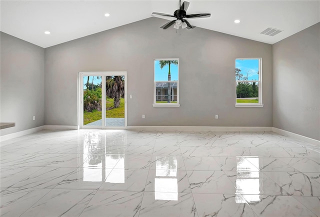 empty room featuring ceiling fan, plenty of natural light, and high vaulted ceiling