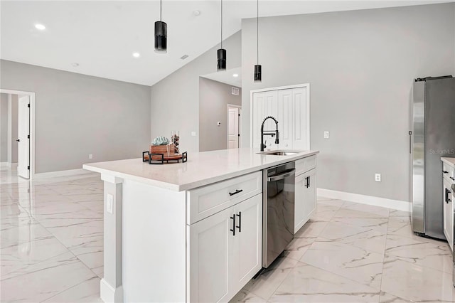 kitchen featuring white cabinets, appliances with stainless steel finishes, sink, hanging light fixtures, and a center island with sink