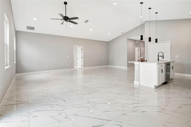 interior space featuring ceiling fan, sink, and high vaulted ceiling