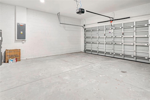 garage with electric panel and a garage door opener