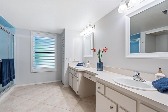 bathroom with tile patterned flooring, vanity, a textured ceiling, and walk in shower