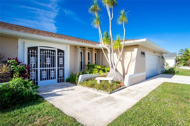 ranch-style home with a front lawn and a garage