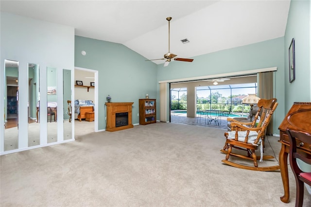 sitting room with high vaulted ceiling, ceiling fan, and light carpet