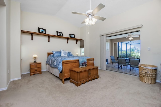 carpeted bedroom with ceiling fan and vaulted ceiling