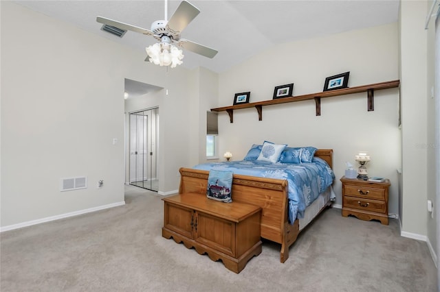 carpeted bedroom with ceiling fan and vaulted ceiling