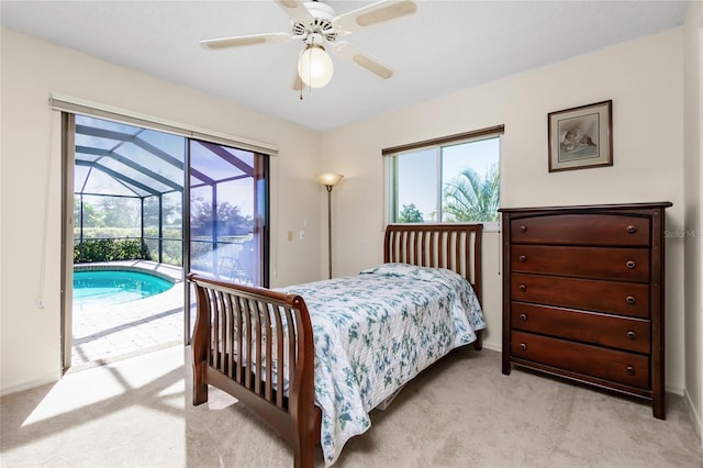 bedroom with ceiling fan, light carpet, multiple windows, and access to exterior