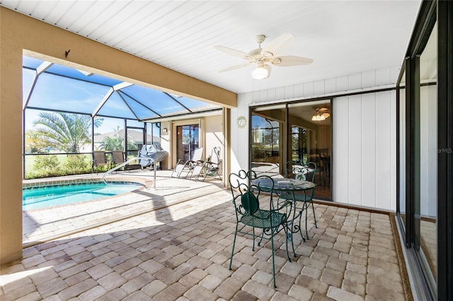 unfurnished sunroom with ceiling fan