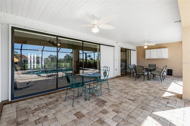 view of patio / terrace featuring washer / dryer, a lanai, and ceiling fan