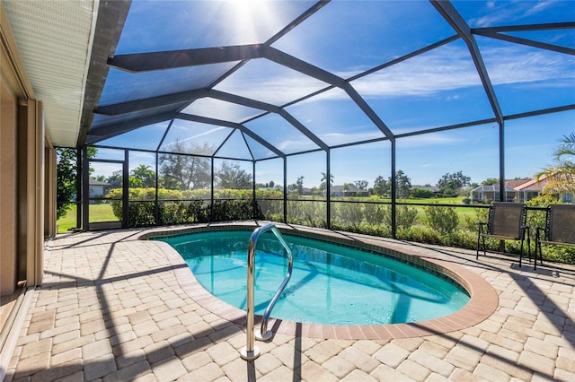 view of pool with a patio and a lanai