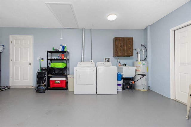 interior space featuring sink, water heater, washing machine and clothes dryer, and cabinets