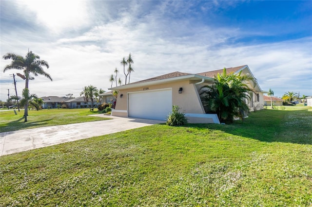 view of front of house with a front yard and a garage