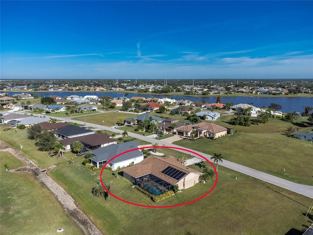 birds eye view of property with a water view