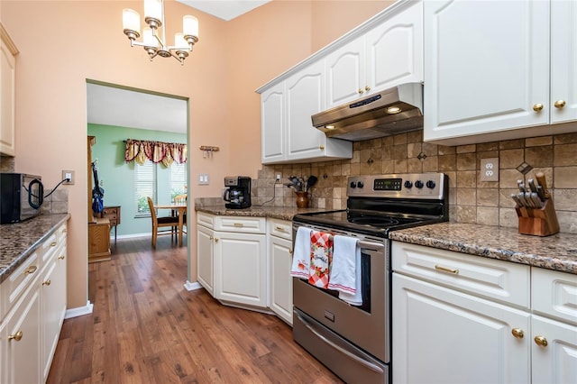 kitchen featuring stainless steel range with electric stovetop, decorative light fixtures, and white cabinetry