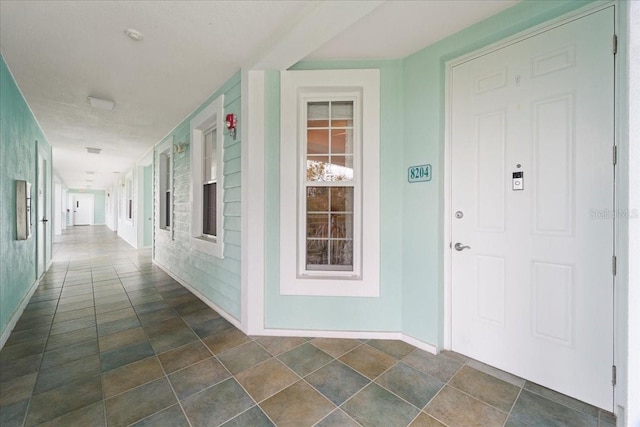 5127 Melbourne St Unit F-204, Port Charlotte, FL 33980 - corridor featuring baseboards and built in shelves