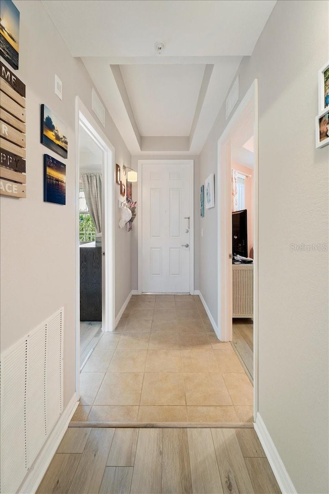 5127 Melbourne St Unit F-204, Port Charlotte, FL 33980 - hall with a tray ceiling and light tile patterned floors