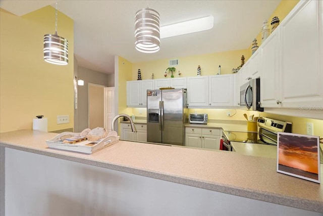 kitchen featuring kitchen peninsula, white cabinetry, pendant lighting, and stainless steel appliances