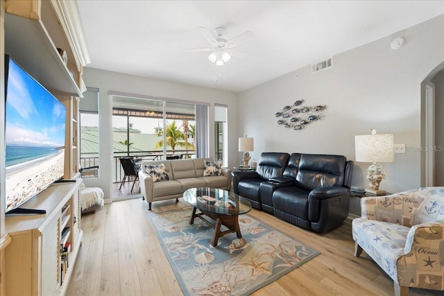 living room featuring ceiling fan and light hardwood / wood-style flooring