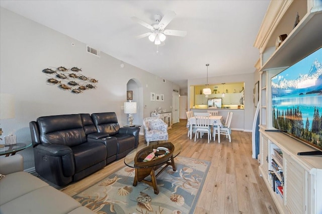 living room featuring ceiling fan and light wood-type flooring