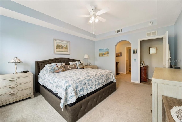 5127 Melbourne St Unit F-204, Port Charlotte, FL 33980 - bedroom featuring arched walkways, light colored carpet, a tray ceiling, and ceiling fan