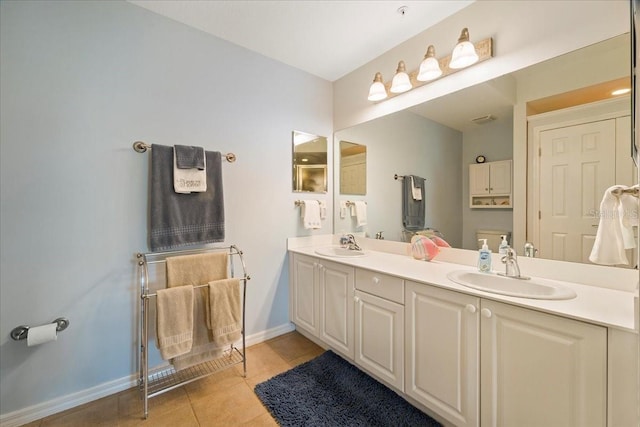 bathroom featuring tile patterned floors, vanity, and toilet