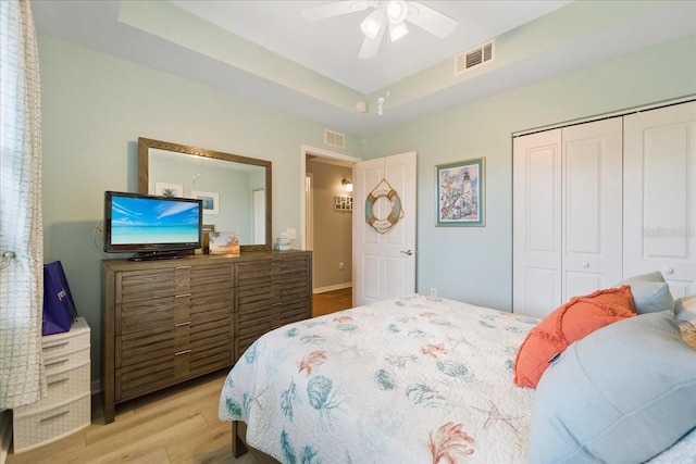 5127 Melbourne St Unit F-204, Port Charlotte, FL 33980 - bedroom featuring light wood-style flooring, a closet, a raised ceiling, and a ceiling fan