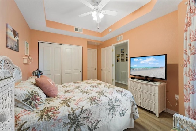 5127 Melbourne St Unit F-204, Port Charlotte, FL 33980 - bedroom with light wood-style flooring, a tray ceiling, a closet, and a ceiling fan