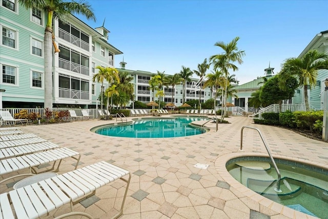 view of pool with a patio area and a hot tub