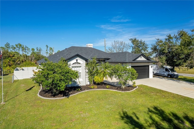 view of front of property with a garage and a front yard