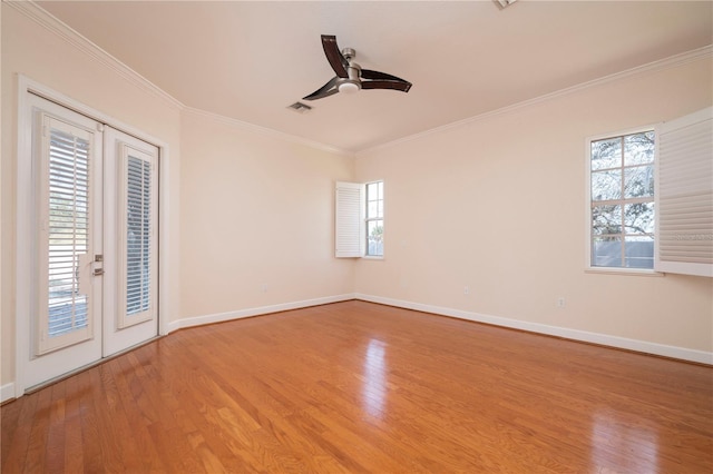 empty room featuring ceiling fan, light hardwood / wood-style flooring, crown molding, and french doors