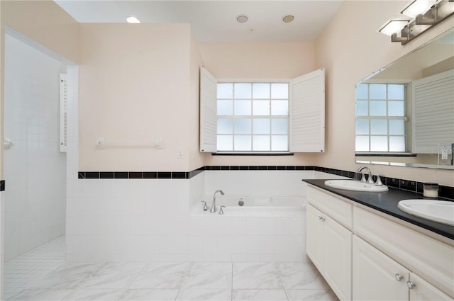 bathroom featuring separate shower and tub and vanity