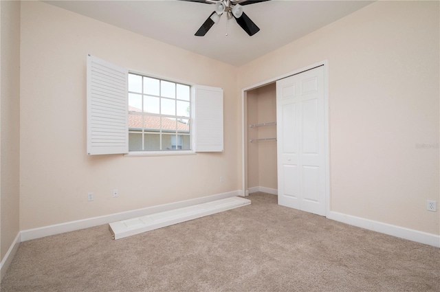 unfurnished bedroom featuring ceiling fan, a closet, and carpet floors