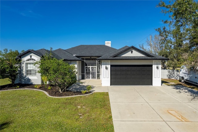 single story home with a front yard and a garage