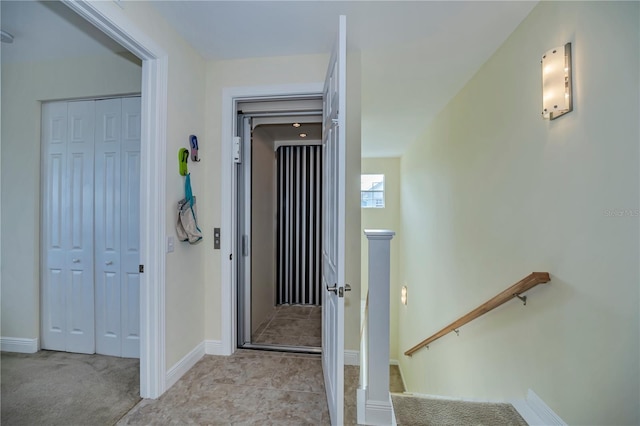 corridor featuring light colored carpet