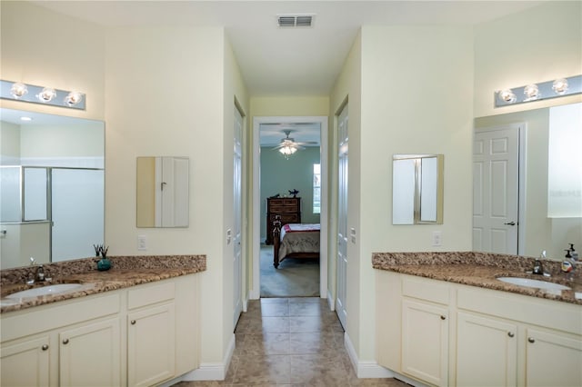 bathroom with vanity, tile patterned flooring, ceiling fan, and walk in shower