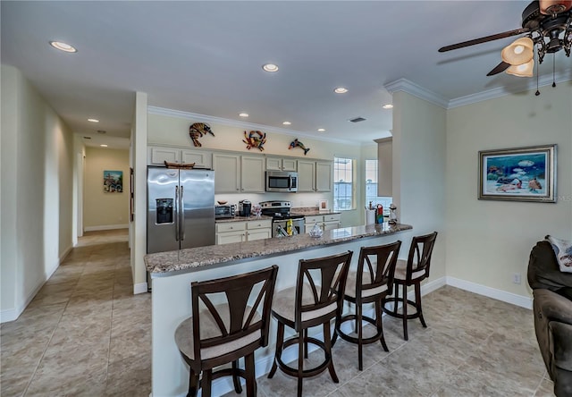 kitchen with ornamental molding, appliances with stainless steel finishes, kitchen peninsula, and light stone countertops