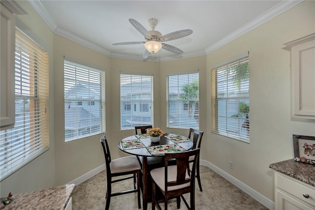 dining area with a wealth of natural light, crown molding, and baseboards