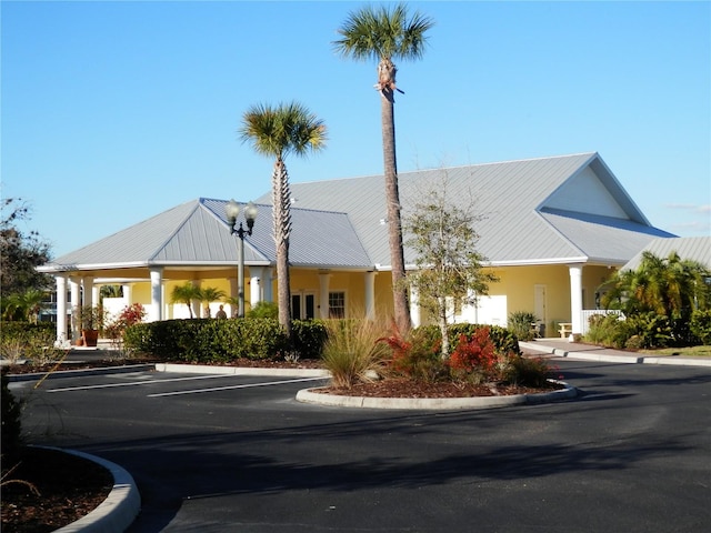 view of building exterior with uncovered parking