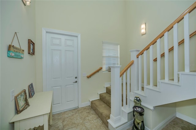 interior space with stairway and baseboards