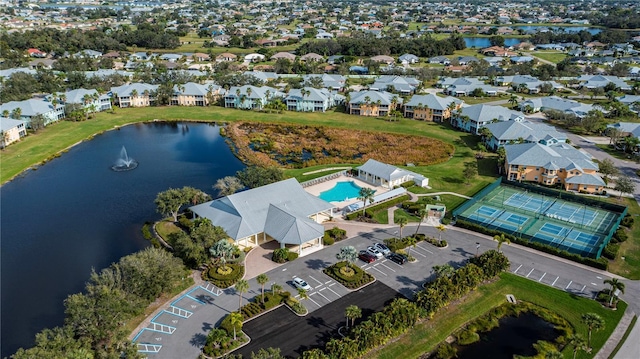 birds eye view of property with a residential view and a water view