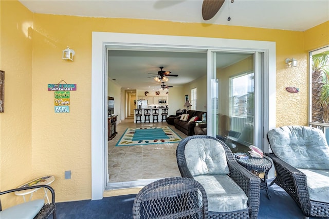 sunroom featuring plenty of natural light and ceiling fan