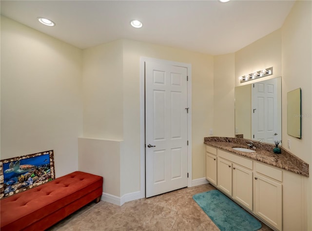 bathroom featuring recessed lighting, baseboards, and vanity