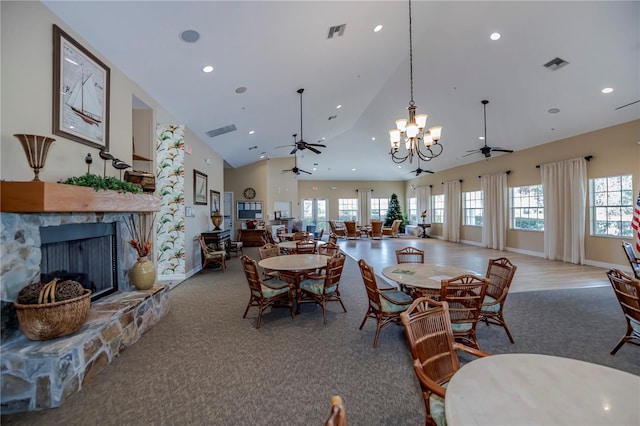 dining area featuring visible vents, high vaulted ceiling, recessed lighting, a stone fireplace, and ceiling fan