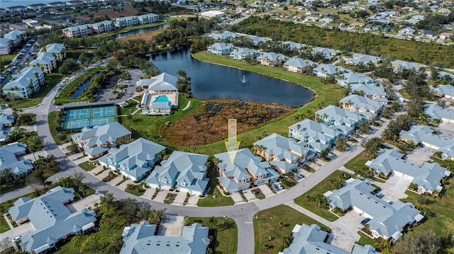 drone / aerial view with a residential view and a water view