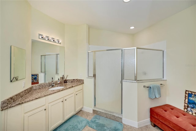 bathroom featuring recessed lighting, a shower stall, vanity, and baseboards