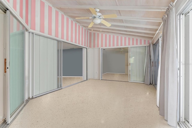 unfurnished sunroom with vaulted ceiling and ceiling fan