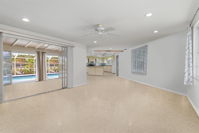 unfurnished living room with ceiling fan