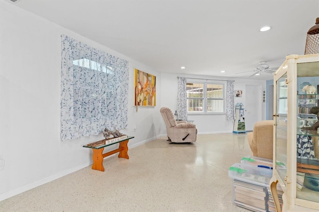 living area featuring ceiling fan