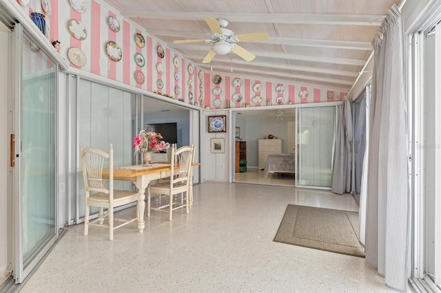 interior space with vaulted ceiling with beams and ceiling fan