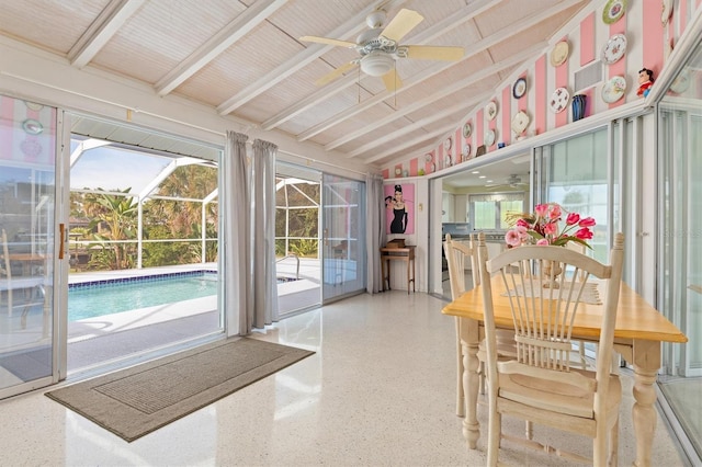 sunroom / solarium featuring ceiling fan and vaulted ceiling with beams